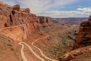 A canyon with a winding road. - Lovely Townhome with Seasonal Shared Pool and Hot Tub and Mountain Views (Moab)