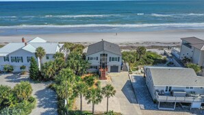 A beachfront property with multiple houses, a driveway, and a view of the ocean. - Welcome to Villa Rosa! A 4 Bedroom 3 Bath Oceanfront Getaway (St. Augustine)