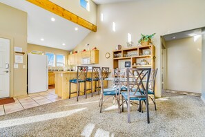 Kitchen area with a large island, sink, and seating space.