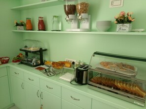 A breakfast buffet with various food items, a coffee machine, and a toaster. - Dreams Tropea Mare (Tropea)