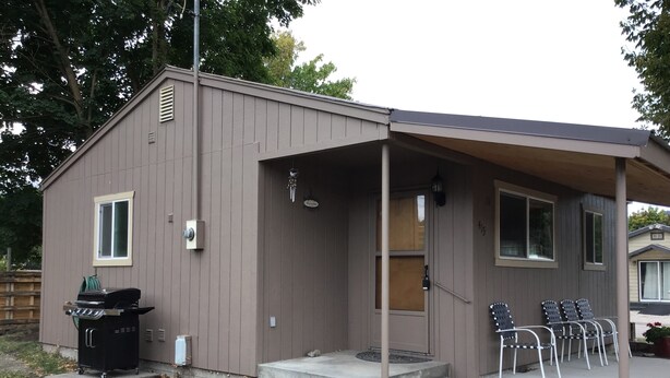 A small, single-story building with a covered porch and a grill outside. - Clean and cute,1 bed, 1 bath, small town setting across from city park. (Plains)
