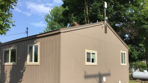 A small, single-story building with two windows and a chimney. - Clean and cute,1 bed, 1 bath, small town setting across from city park. (Plains)