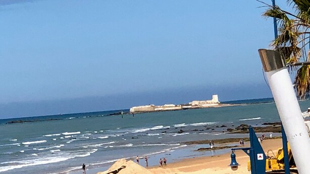 A beach with clear skies, a sandy shore, and a distant building. - Chalet La Costa, close to the beach and with Wifi (Chiclana de la Frontera)