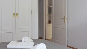 A hotel room with a bed, a pair of white doors, and a visible hallway. - Chalet La Costa, close to the beach and with Wifi (Chiclana de la Frontera)