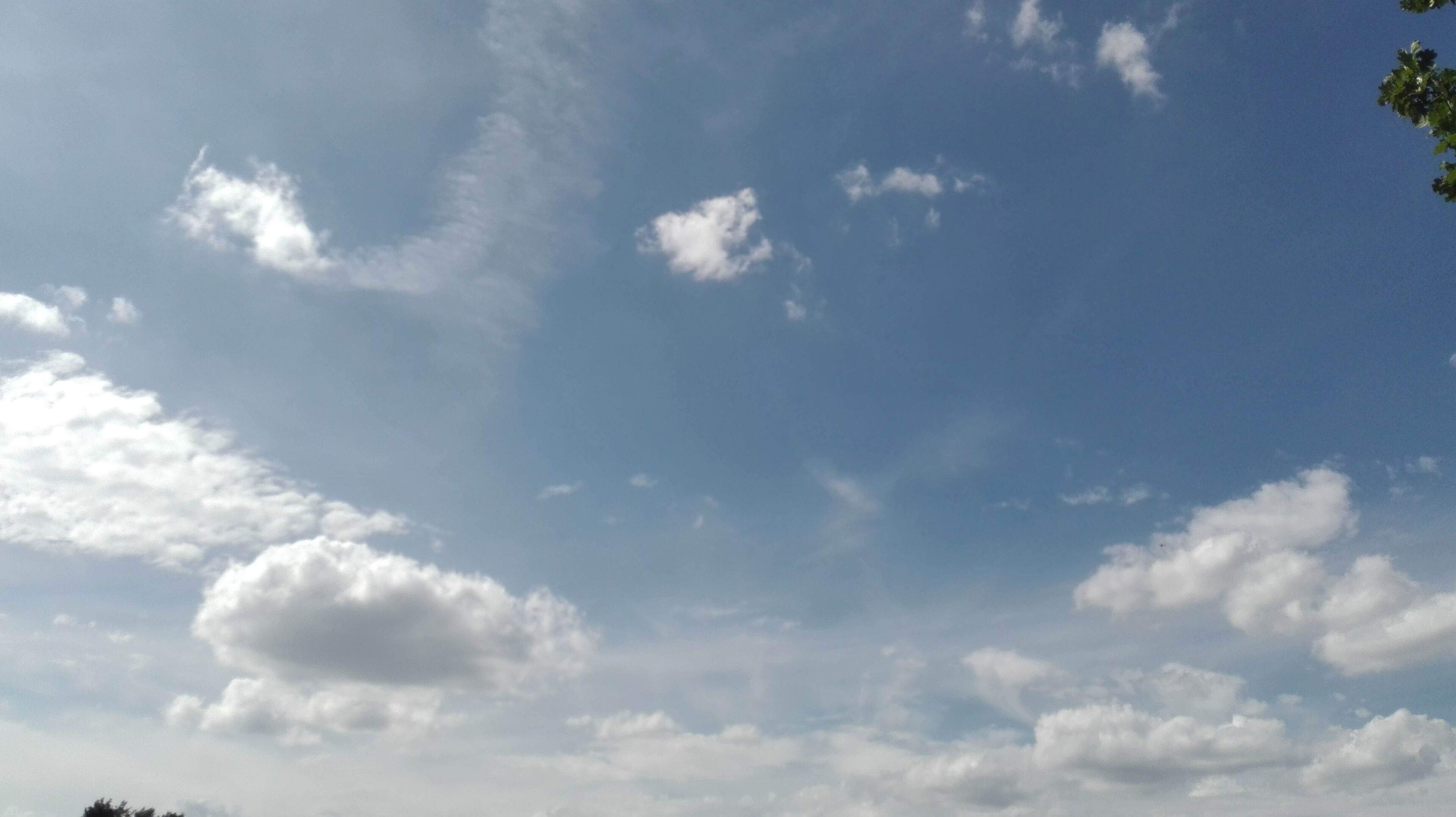 A clear sky with scattered clouds.