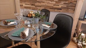 A dining table set with plates, glasses, and a centerpiece. - Naturally happy (170m to the Müritz) (Röbel/Müritz)