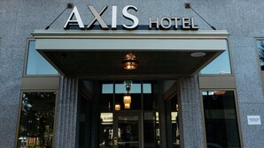 The exterior of the AXIS Hotel with a prominent sign above the entrance. - The Axis Moline Hotel, Tapestry Collection by Hilton (Moline)