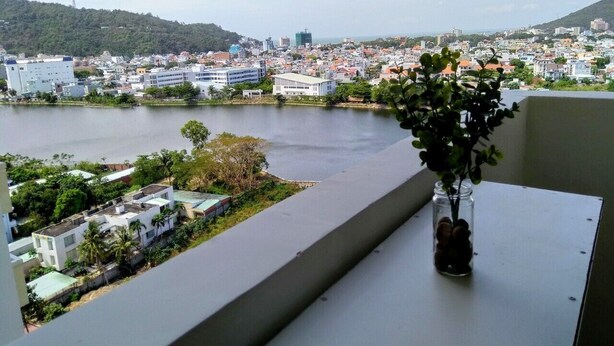 A balcony with a view of a cityscape and a body of water. - Hidden from the noise (Tp. Vũng Tàu)