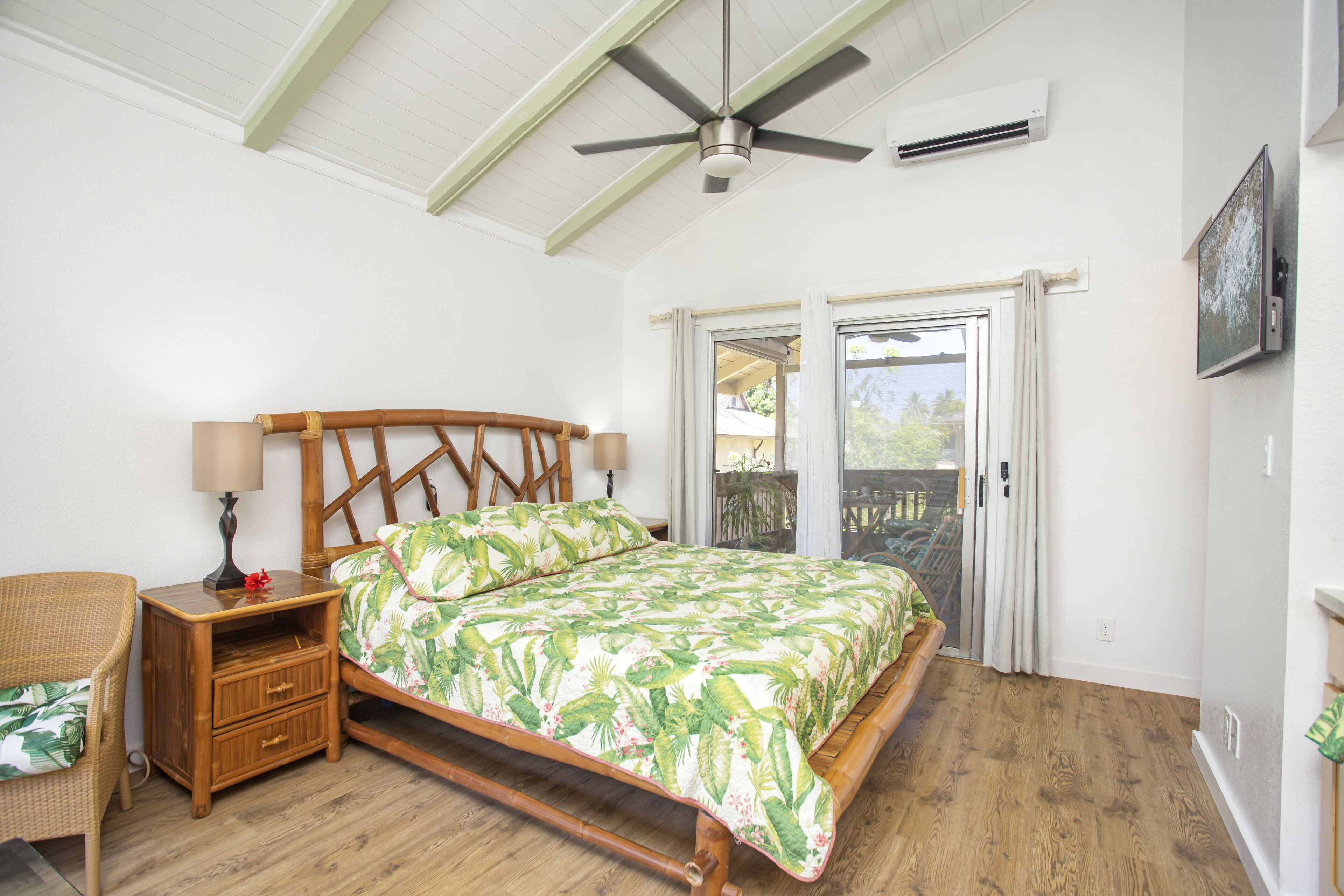 A bedroom with a bed, wooden nightstand, and a chair.