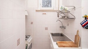 A small kitchen with a sink, a window, and a stove. - N110 - Numana, villa with garden and sea view (Numana)