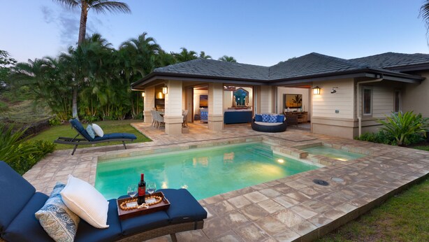 A residential property with a swimming pool, outdoor seating, and a well-maintained garden. - Private Villa, Golf Course Front with a Private Pool and Spa! (Kamuela)