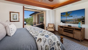 A bedroom with a bed, a chair, a TV, and a view of the outdoors. - Private Villa, Golf Course Front with a Private Pool and Spa! (Kamuela)