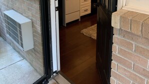 A kitchen with white cabinets, a stove, and a microwave.