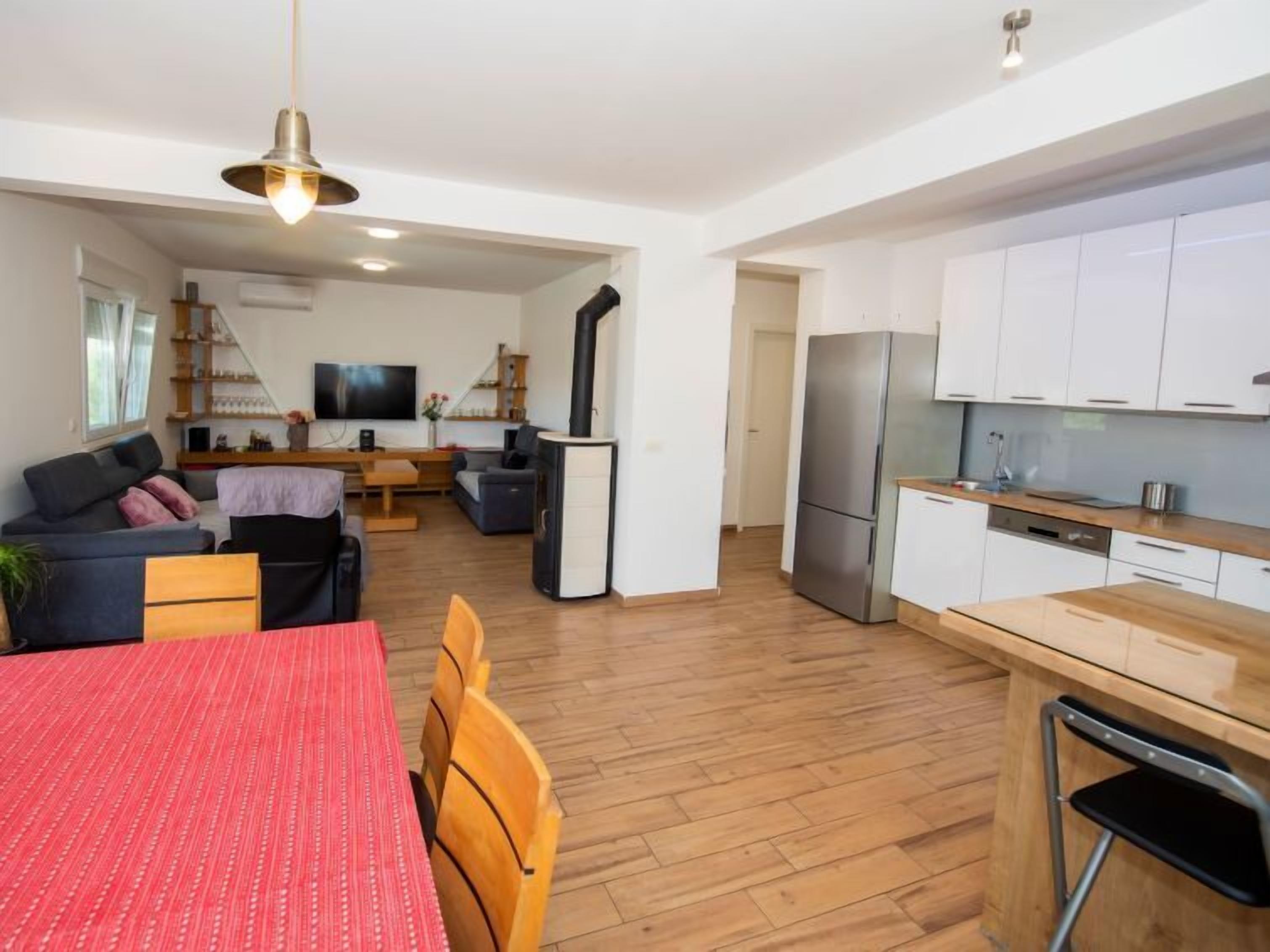 A modern apartment with a dining area, living room, and kitchen.