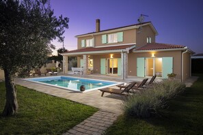A two-story house with a swimming pool, outdoor seating, and a well-maintained garden. - Villa Matea with private pool (Orbanici)