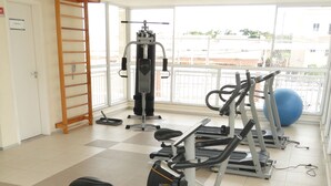 A gym with exercise equipment including treadmills, an elliptical, and a stationary bike.