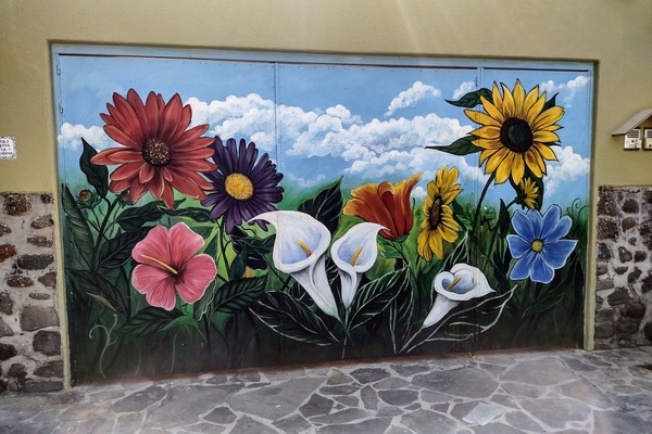 Colorful street mural welcomes you to Casa Felicidad Casita!