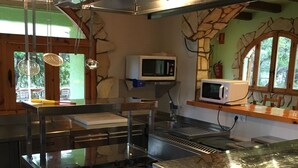 A commercial kitchen with stainless steel appliances, a microwave, and a stove. - Still available from August 17 to August 31! La Xaconera d' Ardenya (Ardenya, Tarragona)