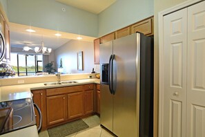 Enjoy cooking in this well-equipped kitchen with a refrigerator, oven, and sink.