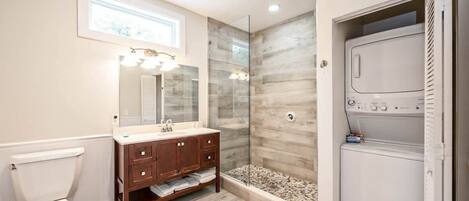 Shower, hair dryer, towels, shampoo