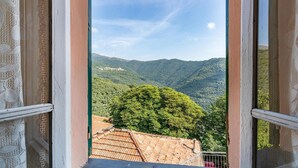 A view from a window overlooking a mountainous landscape with a village in the distance. - 2 bedroom nice home in Valloria (Valloria)