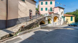 A street with a stone staircase leading to a building with green shutters and a balcony. - 2 bedroom nice home in Valloria (Valloria)