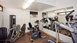 A gym with exercise equipment, a mirror, and a window. - Spacious Studio, Perfect Location In Wakiki, Located Near The Beach, Shopping (Honolulu)