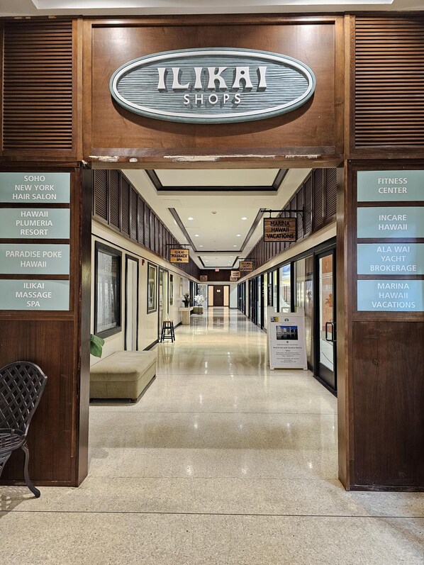 A corridor with a sign for Ilikai Shops at the entrance.
