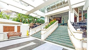 A modern hotel lobby with a staircase, a bench, and a water feature. - Perfect One-Bedroom Unit with an Ocean View! Ilikai Hotel, Great Location!  Going fast!  A++++ (Honolulu)