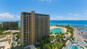 A high-rise hotel with multiple balconies overlooking a beach and ocean. - Perfect One-Bedroom Unit with an Ocean View! Ilikai Hotel, Great Location!  Going fast!  A++++ (Honolulu)
