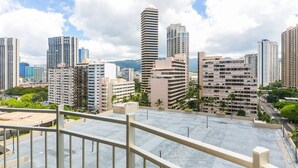 A high-rise building with a modern design, featuring multiple balconies and a rooftop terrace. - Near Waikiki Beach, Spacious Studio With Full Kitchen! (Honolulu)