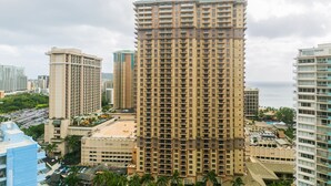 A high-rise hotel with multiple floors, a rooftop pool, and a view of the ocean. - Great Location In Wakiki, Walking Distance To Beach, Shopping, Dining! (Honolulu)