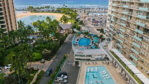 A hotel with a pool, beach view, and multiple balconies. - Ilikai Hotel One-bedroom Unit with am AMAZING view of the Duke Kahanamoku Lagoon and Waikiki Beach (Honolulu)