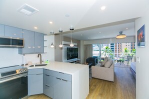 Enjoy a comfortable stay in this stylish apartment with a compact kitchen, central island, and city view from the balcony.