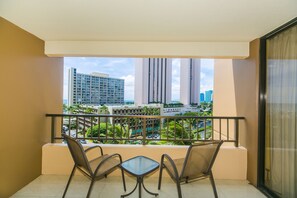 Enjoy the city view from this balcony with a table and two chairs.