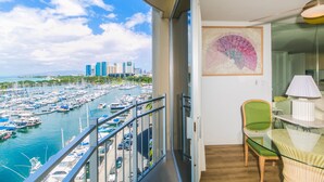 A balcony with a view of a marina and city skyline. - Marina Hawaii Vacations - Beautiful 180 Degree Ocean Views! (Honolulu)