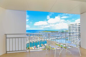 A balcony with a view of a marina and ocean. - Highly desirable Deluxe One-bedroom Yacht Harbor View - Reserve Today, Will not last Long!! (Honolulu)