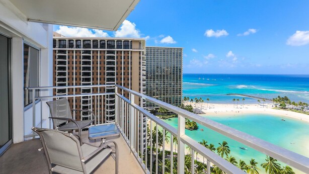 A balcony with a view of a beach and ocean, a chair, and a table. - Ilikai Hotel, Amazing Ocean views! Most desirable location in Ilikai! (Honolulu)