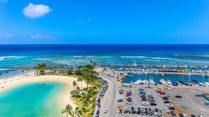 A marina with boats, a parking lot, and a beach. - Ilikai Hotel, Amazing Ocean views! Most desirable location in Ilikai! (Honolulu)