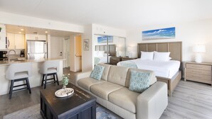 Une chambre d’hôtel comprenant un lit, un canapé, un coin repas et une cuisine.
