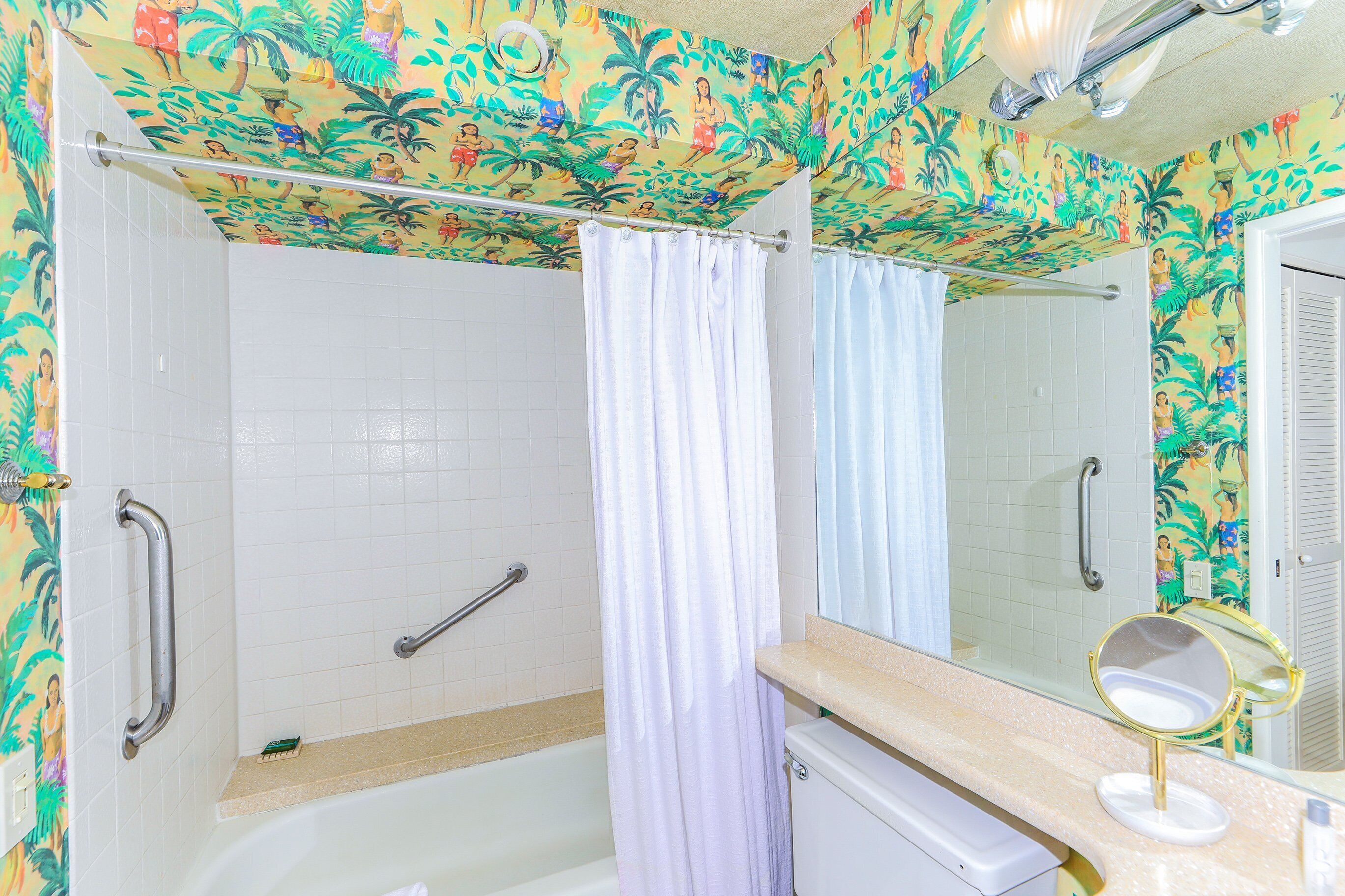 A bathroom with a shower, a toilet, a sink with a mirror, and a towel rack.