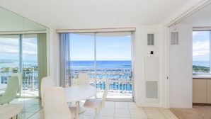Ein modernes Hotelzimmer mit Balkon mit Blick auf einen Hafen und das Meer.