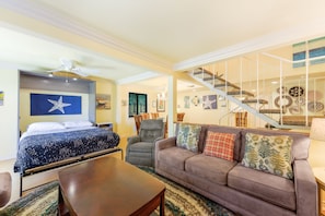 A hotel room with a bed, a sofa, a dining table, a staircase, and artwork on the walls. - 12CT: Updates Spacious Townhome w/ Patio, Private Balcony, BBQ (Avalon)