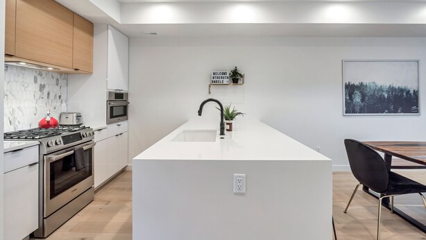 A modern kitchen with white cabinetry, stainless steel appliances, and a central island. - Downtown Central 9th SLC Loft Walk or Trax to Convention Center (Salt Lake City)
