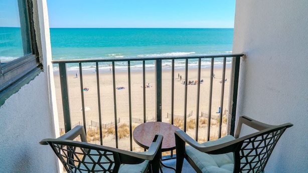 A balcony with a view of a beach and ocean. - The Four Oh One | Palace (Myrtle Beach)