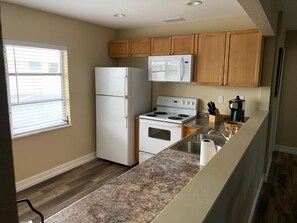 Fridge, microwave, stovetop, coffee/tea maker