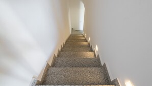 A staircase with a carpeted floor and white walls. - Luxurious Holiday Home with Pool, Terrace, Wi-Fi & Air Conditioning; Parking Available, Smaller Pets Allowed (domus de maria)
