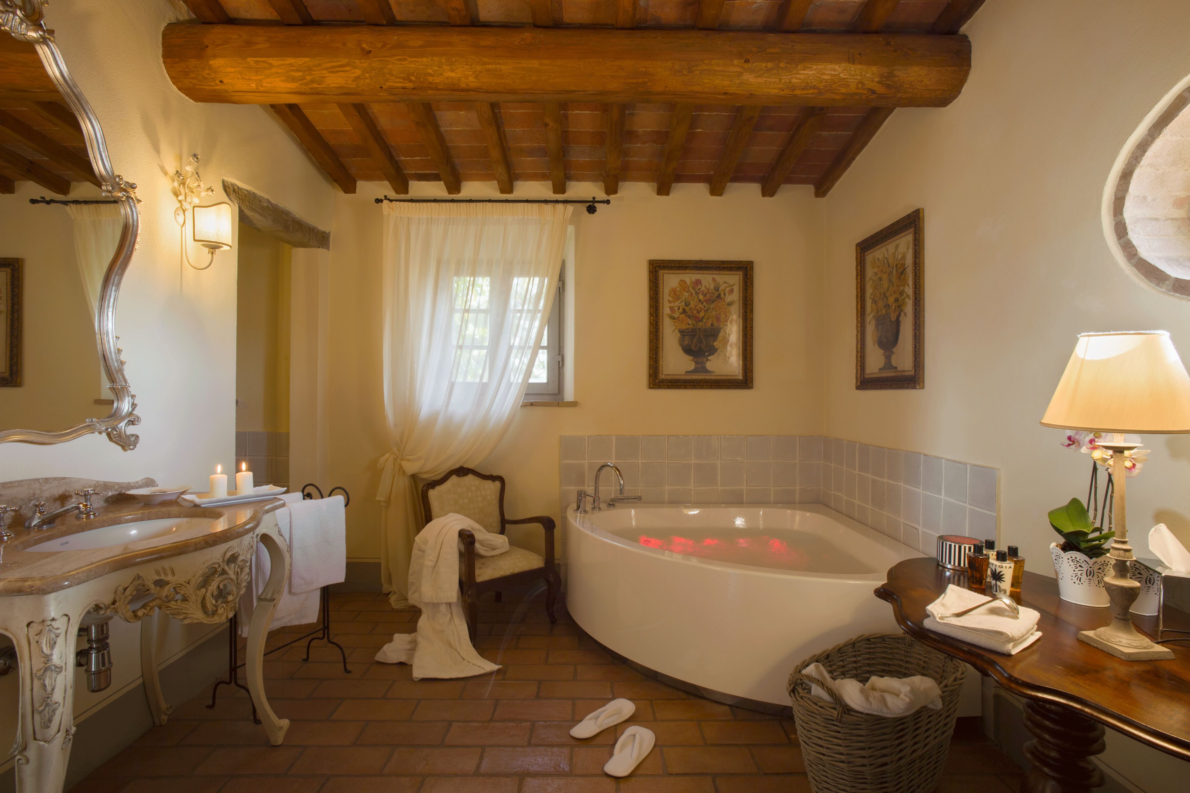 A bathroom with a bathtub, a sink, a mirror, and a towel rack.