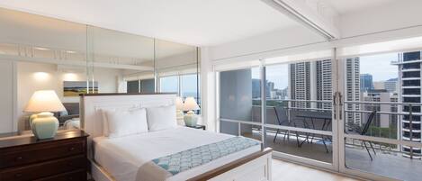 A modern bedroom with a large bed, bedside lamps, a dresser, and a balcony with a city view.