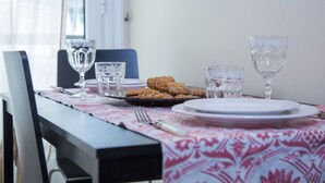 A dining table with a plate of cookies, two glasses, and a fork. - Margarita's home cozy home! (Athina)